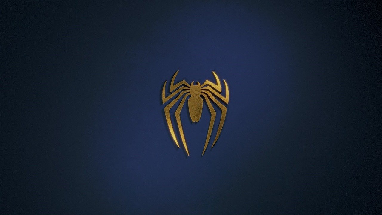 A photo of spiderman’s emblem against a dark blue background.
